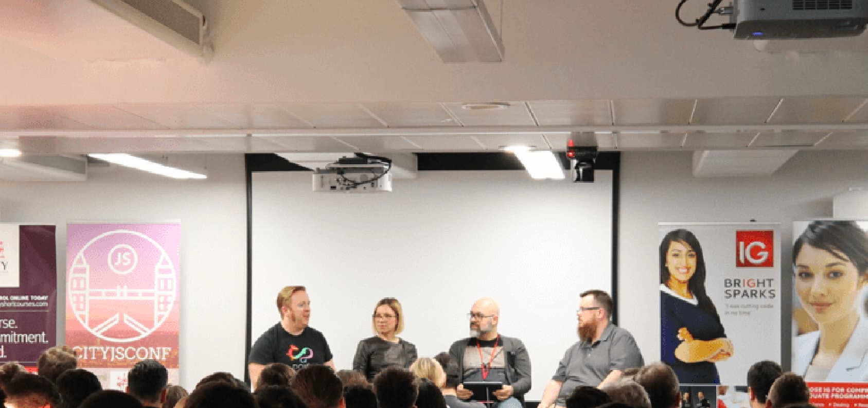 Speakers sharing their experience on the CityJS conference stage